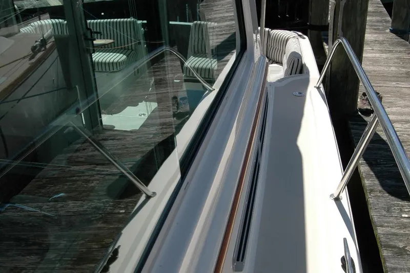 Slide: The Image of 2014 Back Cove 37 yacht with striped seating and sleek glass windows. - 48