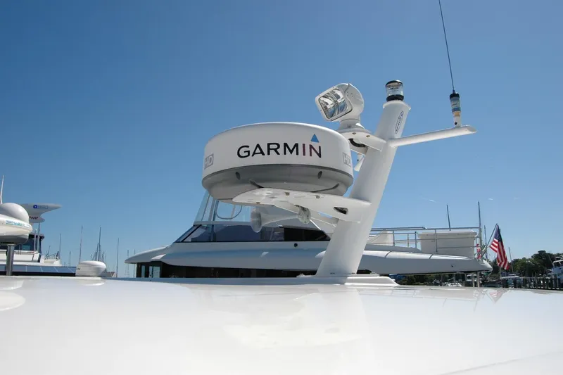 Slide: The Image of 2014 Back Cove 37 yacht with Garmin radar system under clear blue sky. - 49