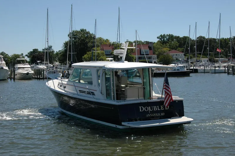 Slide: The Image of 2014 Back Cove 37 boat in marina, Annapolis, MD, with American flag. - 5