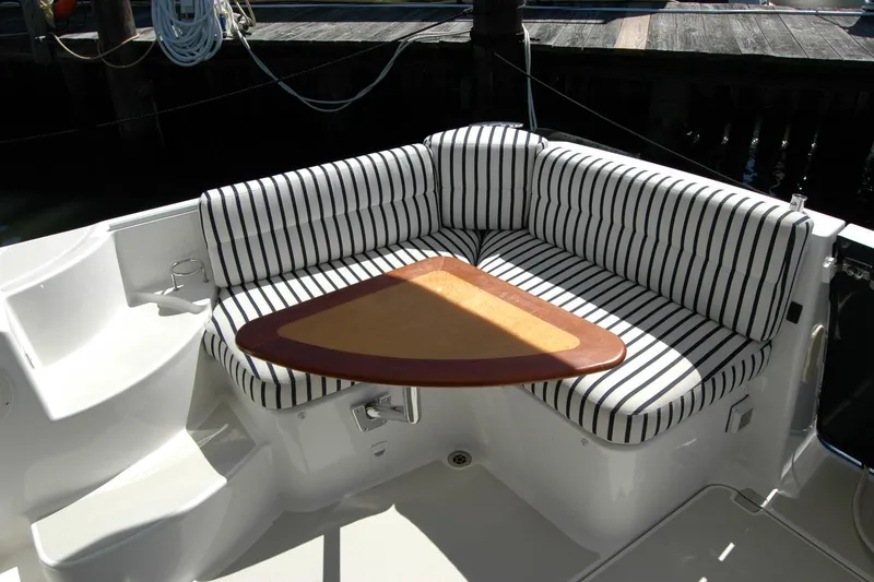 Slide: The Image of 2014 Back Cove 37 boat with striped seating and triangular table in cockpit area. - 53