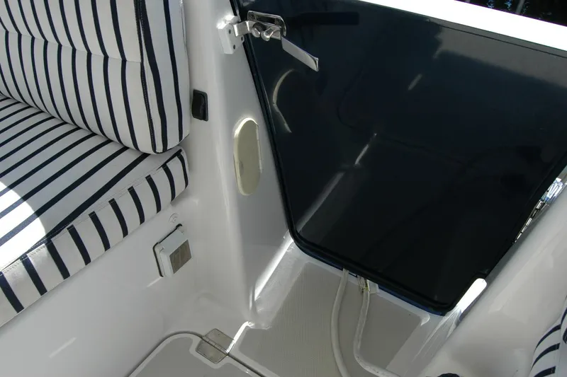 Slide: The Image of 2014 Back Cove 37 boat interior with striped seating and dark glass door. - 54