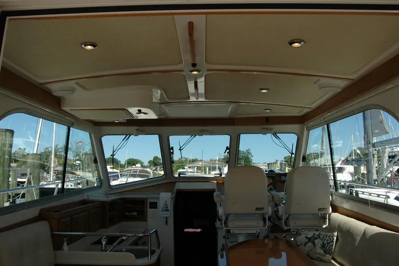 Slide: The Image of Interior view of 2014 Back Cove 37 yacht with helm and seating area. - 57