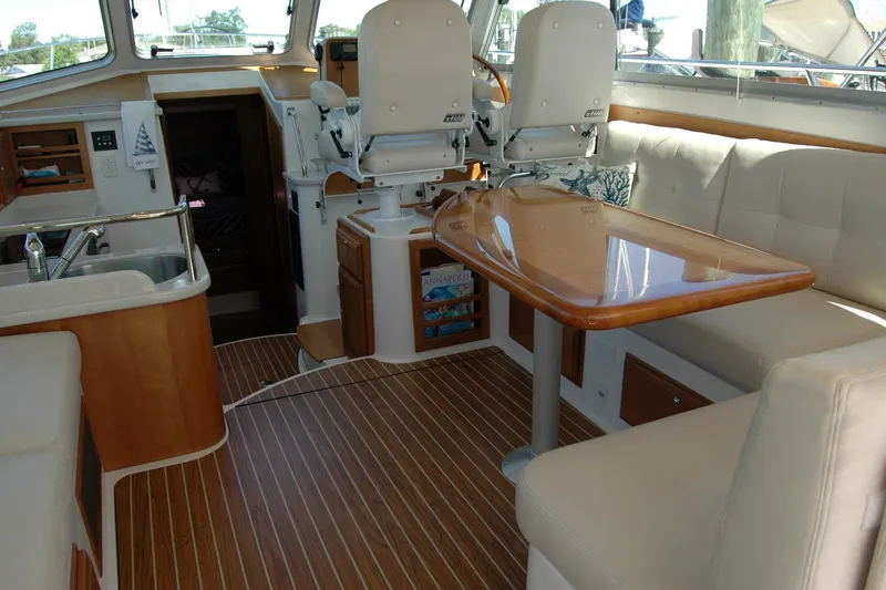 Slide: The Image of Interior of 2014 Back Cove 37 yacht with seating, table, and helm chairs. - 58