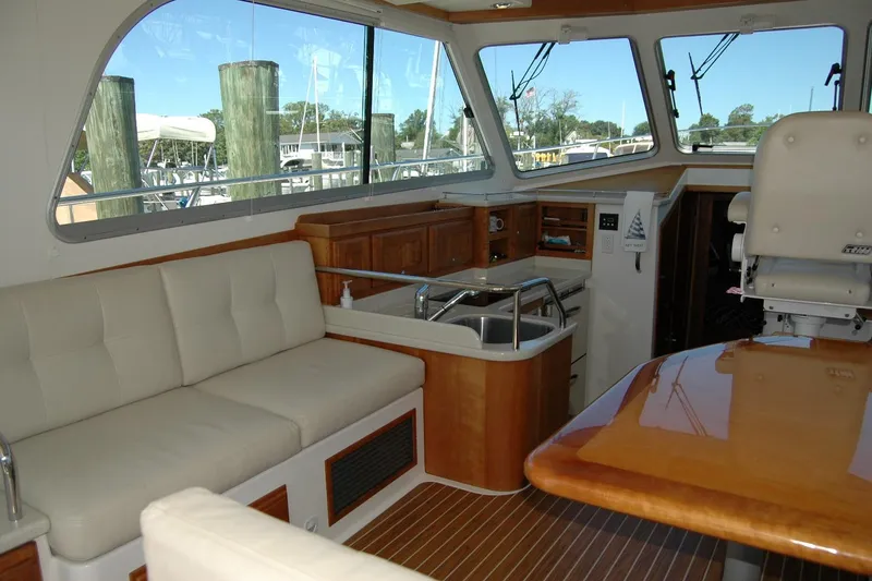 Slide: The Image of Interior of a 2014 Back Cove 37 yacht with seating, kitchenette, and helm station. - 59