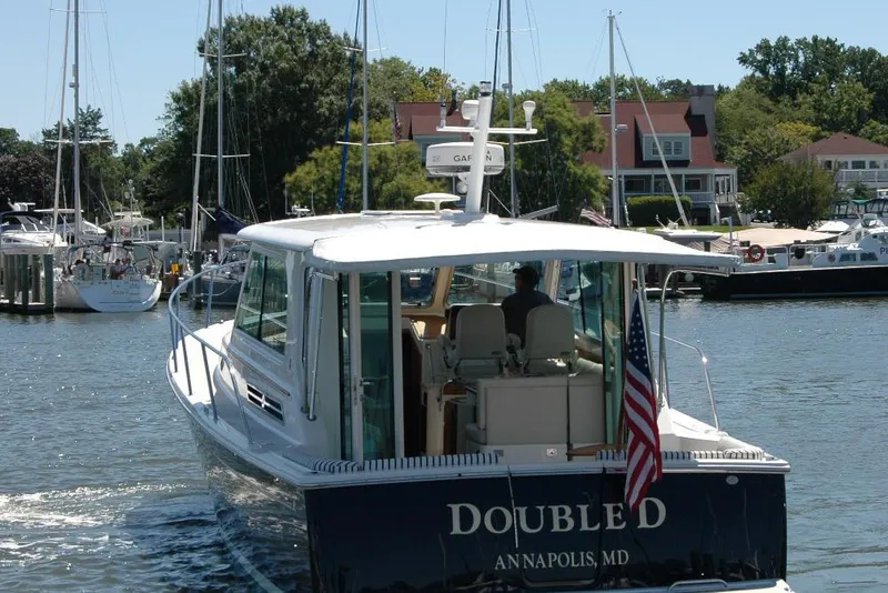 Slide: The Image of 2014 Back Cove 37 boat in marina, Annapolis, MD, with American flag. - 6