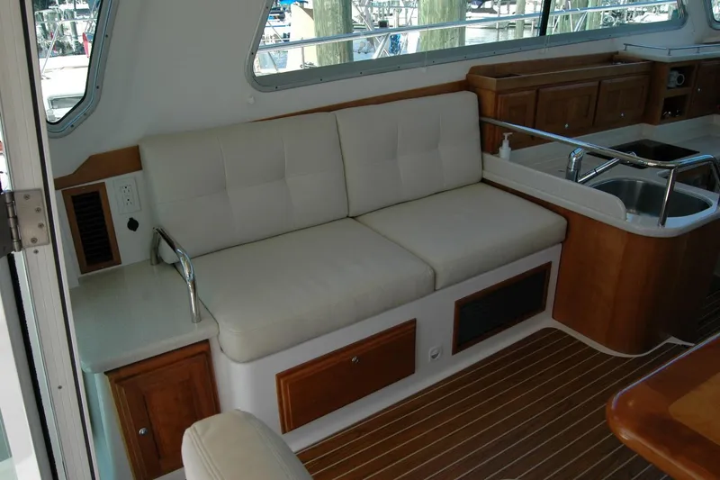 Slide: The Image of Interior of 2014 Back Cove 37 yacht with cushioned seating and wooden cabinetry. - 60