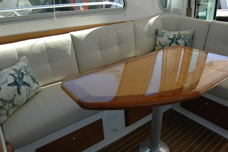 Slide: The Image of Luxurious interior of 2014 Back Cove 37 yacht with cushioned seating and elegant wooden table. - 66