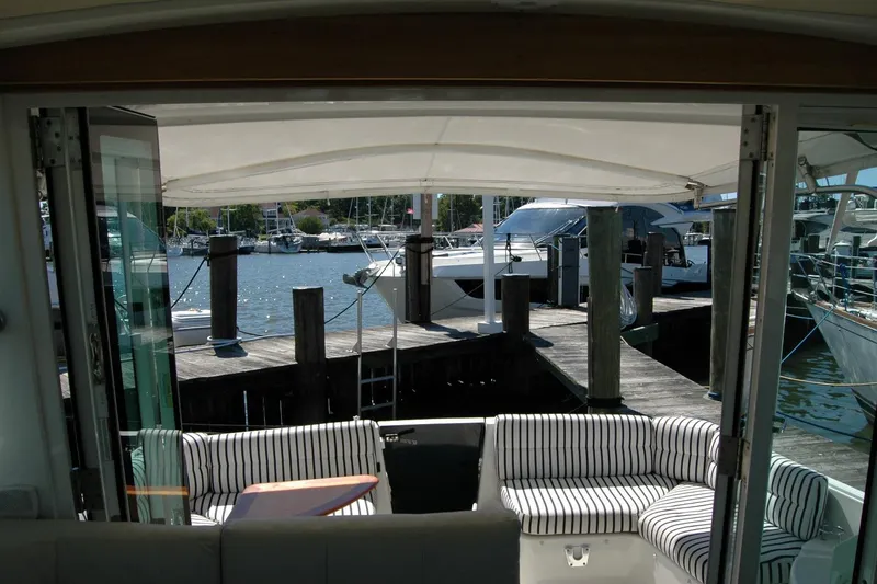 Slide: The Image of 2014 Back Cove 37 yacht interior with striped seating, docked at marina. - 67