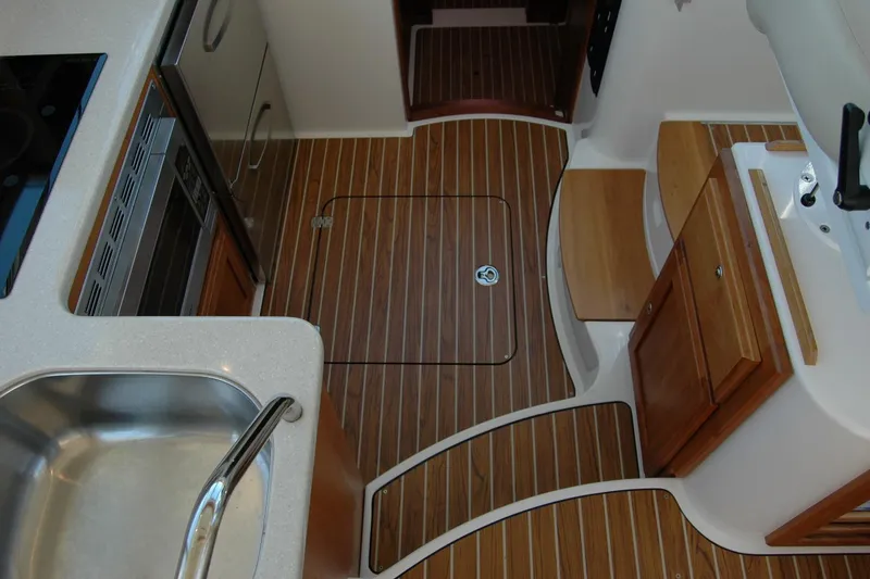 Slide: The Image of 2014 Back Cove 37 yacht interior with wood flooring and modern kitchen amenities. - 72