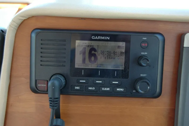 Slide: The Image of Garmin marine radio on 2014 Back Cove 37, displaying distress signal coordinates. - 75