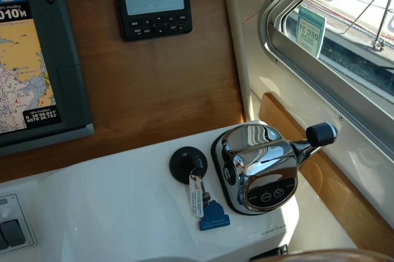 Slide: The Image of Control panel of a 2014 Back Cove 37 boat with navigation equipment and throttle. - 78