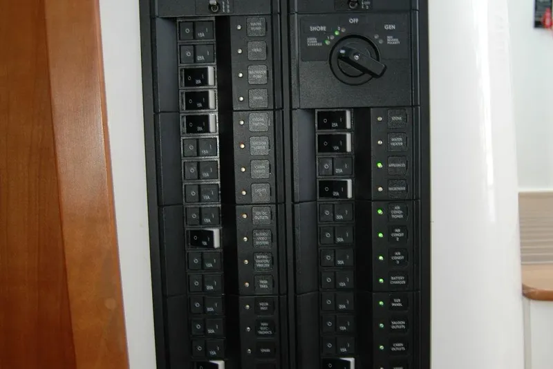 Slide: The Image of Electrical panel of a 2014 Back Cove 37 boat, featuring circuit breakers and switches. - 82