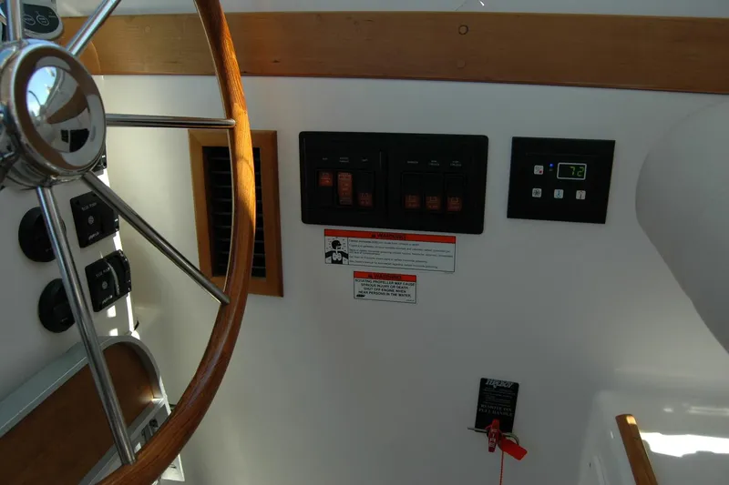 Slide: The Image of 2014 Back Cove 37 helm with wooden steering wheel and control panel. - 83