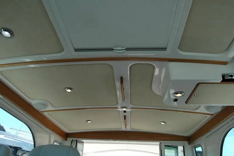Slide: The Image of Interior ceiling of a 2014 Back Cove 37 boat with recessed lighting and wood accents. - 87