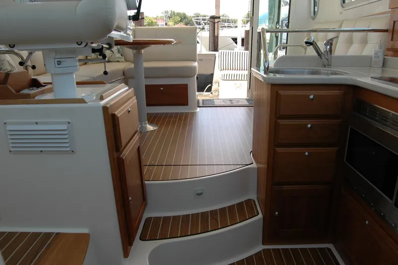 Slide: The Image of Interior of a 2014 Back Cove 37 boat featuring a kitchen and seating area. - 88