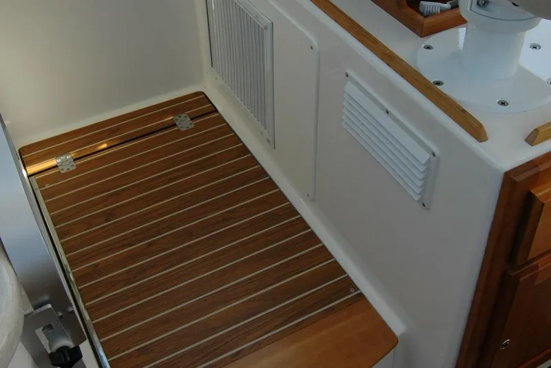 Slide: The Image of 2014 Back Cove 37 interior with wooden flooring and white paneling. - 90
