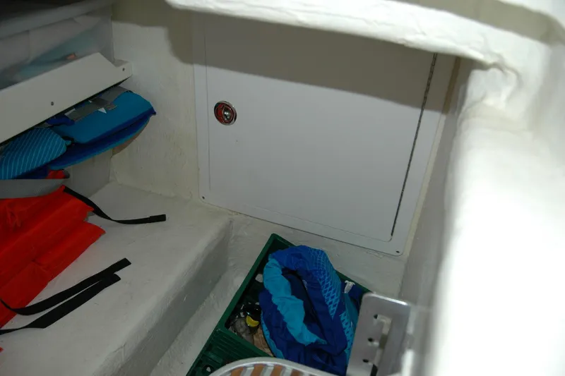 Slide: The Image of Storage compartment in a 2014 Back Cove 37 boat with life jackets and gear. - 94
