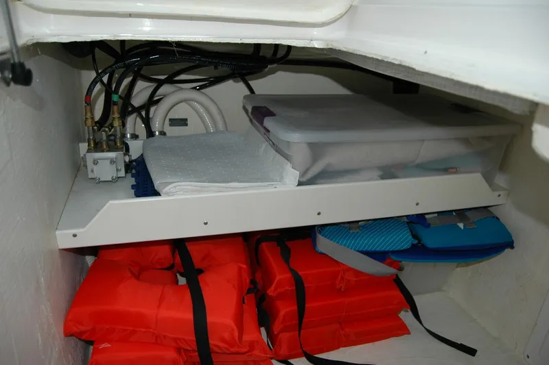Slide: The Image of Storage compartment in a 2014 Back Cove 37 boat with life jackets and supplies. - 95