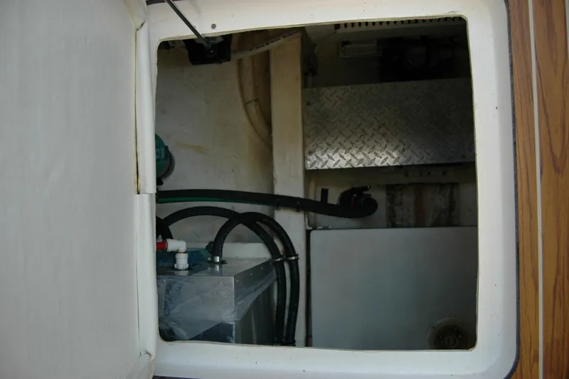 Slide: The Image of 2014 Back Cove 37 engine compartment with hoses and metal panel. - 96