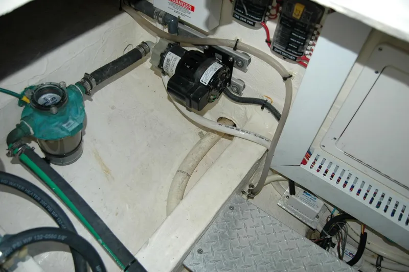 Slide: The Image of Engine compartment of a 2014 Back Cove 37 boat, showing mechanical components and wiring. - 97