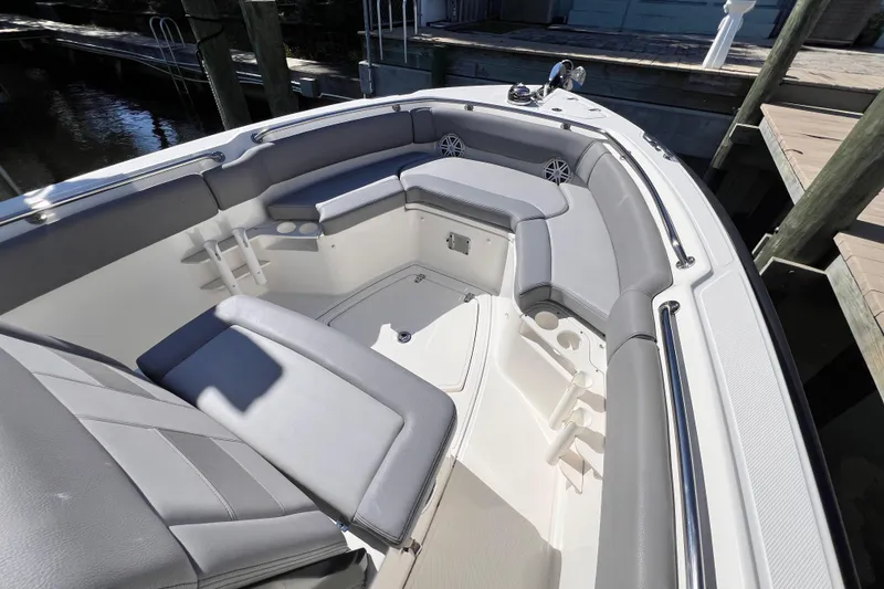 Slide: The Image of 2023 Boston Whaler 230 Outrage boat interior with cushioned seating and cup holders. - 13