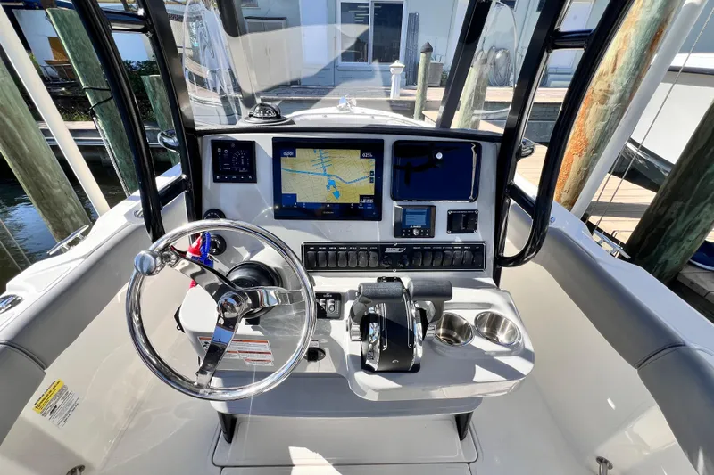 Slide: The Image of 2023 Boston Whaler 230 Outrage boat dashboard with navigation system and controls. - 14