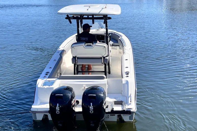 Slide: The Image of 2023 Boston Whaler 230 Outrage boat with dual Mercury engines on water. - 7