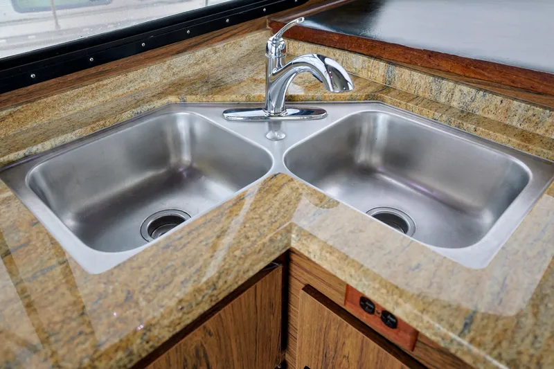 Slide: The Image of Double stainless steel sink with granite countertop on 1980 Pacifica 41 Sportfisher. - 11