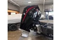 Slide: The Image of 2026 Phoenix ZXL Series 721 boat engine in showroom, featuring sleek black and red design. - 13