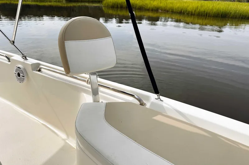 Slide: The Image of 2021 Bulls Bay 2200 boat interior with beige seating by calm waters. - 15