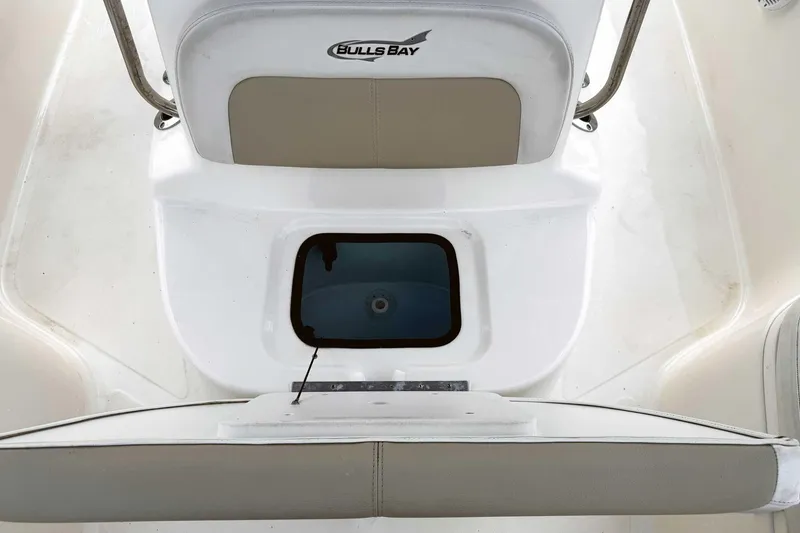 Slide: The Image of 2021 Bulls Bay 2200 boat interior with seating and storage compartment. - 18