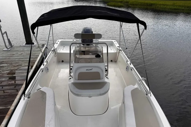 Slide: The Image of 2021 Bulls Bay 2200 boat with canopy docked on calm water. - 23