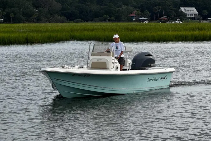 Slide: The Image of 2021 Bulls Bay 2200 boat cruising on a calm river with lush greenery. - 3