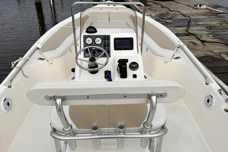 Slide: The Image of 2021 Bulls Bay 2200 boat interior with steering console and seating at dock. - 7