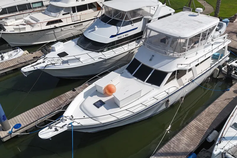 Slide: The Image of White Prima 52 Seahorse yacht docked at marina, 2001 model, surrounded by other boats. - 0