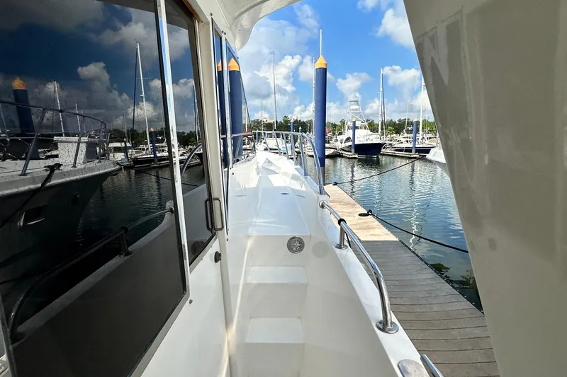 Slide: The Image of Side view of 2001 Prima 52 Seahorse yacht docked at marina. - 12