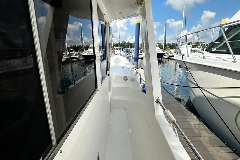 Slide: The Image of 2001 Prima 52 Seahorse yacht docked at marina, sunny day, clear sky, calm water. - 13
