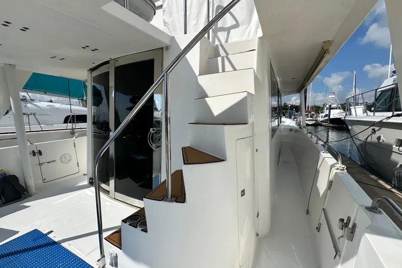Slide: The Image of Deck view of 2001 Prima 52 Seahorse yacht with stairs and marina backdrop. - 14