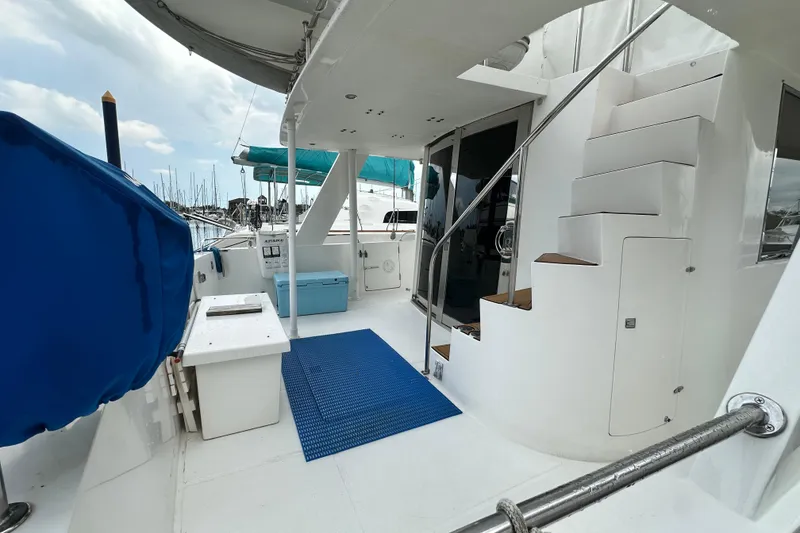 Slide: The Image of Deck view of 2001 Prima 52 Seahorse yacht with stairs and marina backdrop. - 17