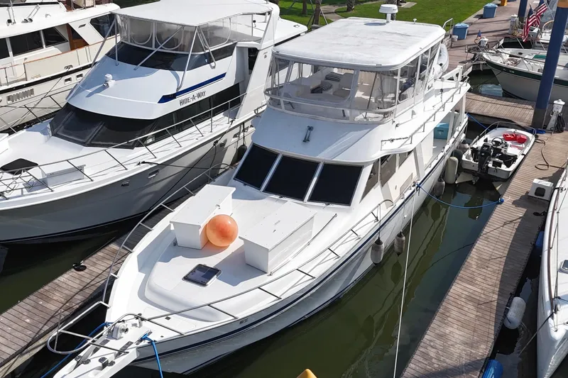 Slide: The Image of White Prima 52 Seahorse yacht docked at marina, 2001 model, surrounded by other boats. - 3