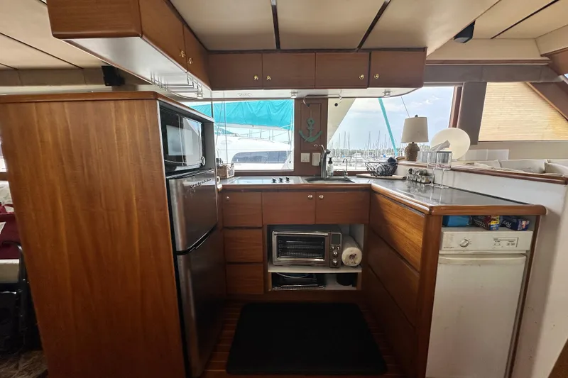 Slide: The Image of Kitchen area of 2001 Prima 52 Seahorse yacht with wood cabinetry and modern appliances. - 37