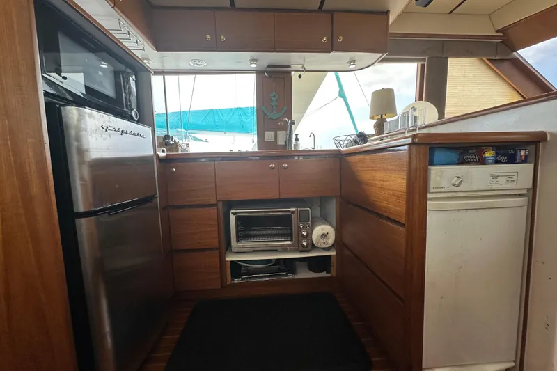 Slide: The Image of Kitchen area of 2001 Prima 52 Seahorse yacht with wooden cabinets and appliances. - 40