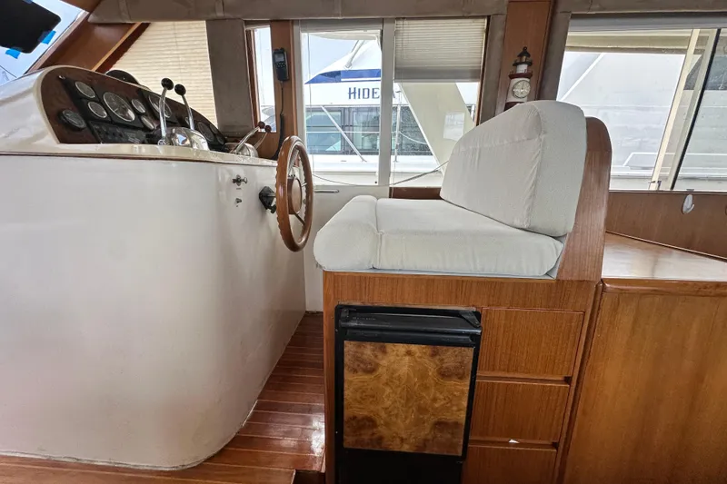 Slide: The Image of Interior helm of 2001 Prima 52 Seahorse yacht with steering wheel and cushioned seat. - 46
