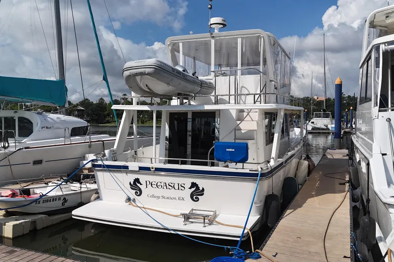 Slide: The Image of Prima 52 Seahorse 2001 yacht "Pegasus" docked at marina under cloudy sky. - 5