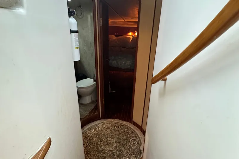 Slide: The Image of Narrow hallway in 2001 Prima 52 Seahorse yacht with visible bathroom and bedroom. - 52