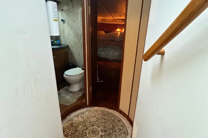 Slide: The Image of Interior of 2001 Prima 52 Seahorse yacht showing bathroom and cozy bedroom. - 53