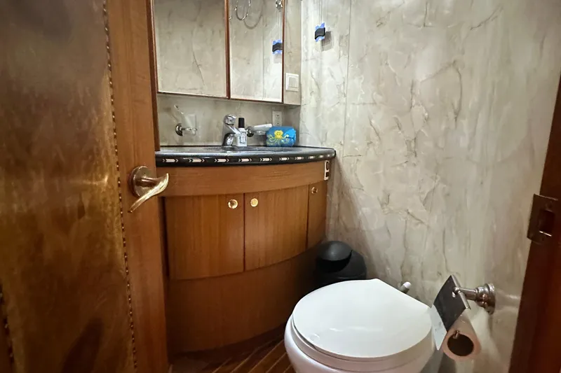 Slide: The Image of Luxurious bathroom in 2001 Prima 52 Seahorse yacht with marble walls and wooden cabinetry. - 56