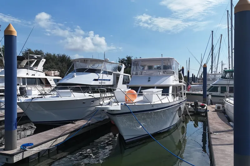 Slide: The Image of Boats docked at marina, featuring a 2001 Prima 52 Seahorse under a clear blue sky. - 6