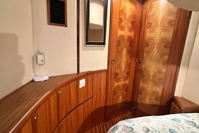 Slide: The Image of Luxurious wooden interior of 2001 Prima 52 Seahorse yacht cabin with elegant cabinetry and doors. - 62