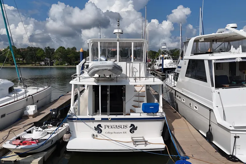 Slide: The Image of Docked Prima 52 Seahorse yacht, 2001 model, with clear skies and surrounding boats. - 8